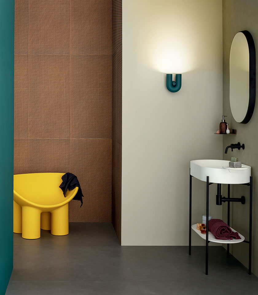 Modern bathroom with textured surfaces, neutral tones and vibrant colour accents.