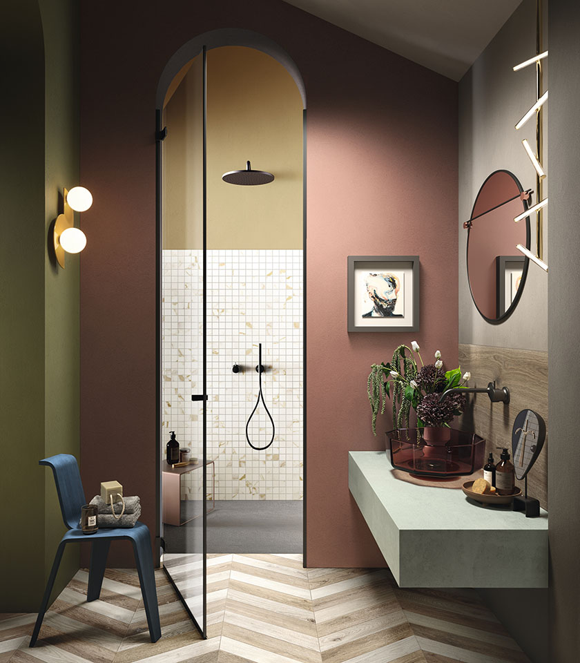 Contemporary bathroom with coloured walls, wood-effect flooring and refined decorative details.