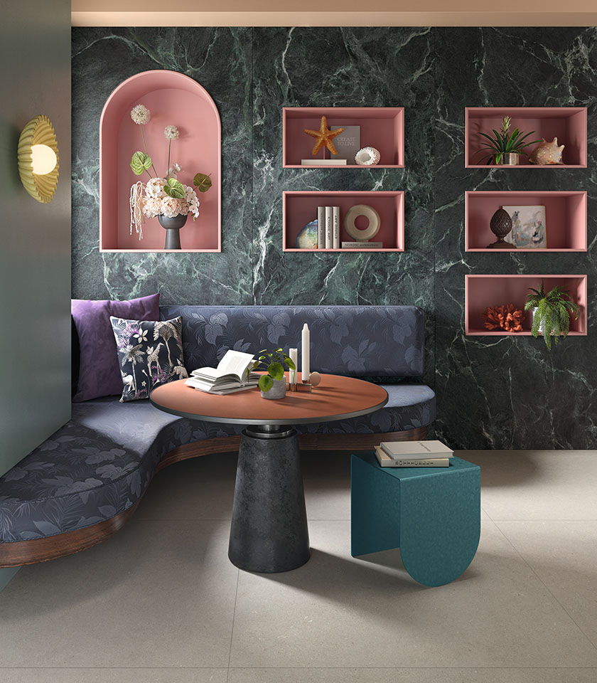 Contemporary living room with a green marble-effect wall, pink niches and softly shaped furniture.