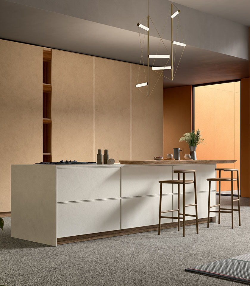 Contemporary kitchen with a central island and stools, featuring coverings from the Pigmenti collection in Harvest, Mist and Sunset shades, paired with Piece Dark flooring.