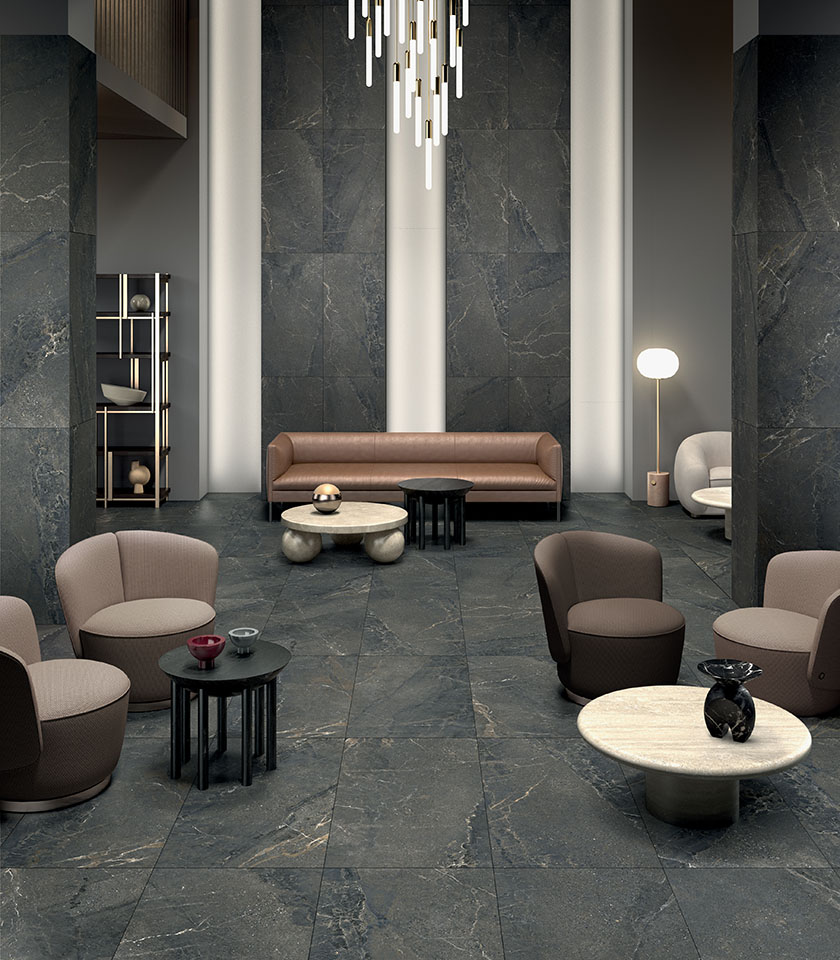 Contemporary living room with flooring and wall coverings from the Anthology collection in Dark Natural stone effect.