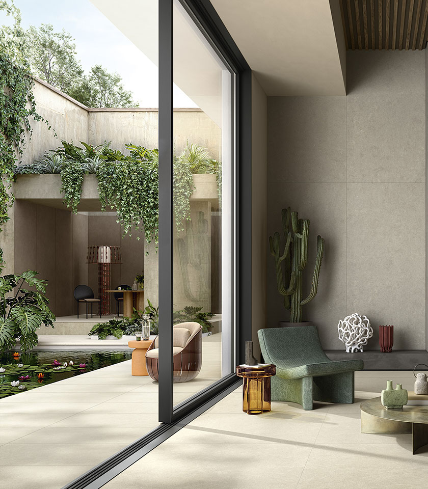Contemporary indoor-outdoor living space with flooring from the Intense collection in Clair stone effect, wall covering in the Perle shade and elements from the Pigmenti collection in the Pumice shade.