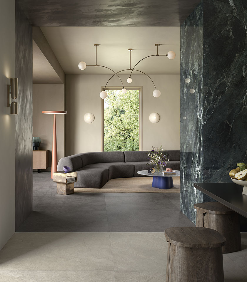 Contemporary living room with flooring from the Pulse collection in Clay and Shadow stone effect and wall covering from the Noblesse collection in Verde Alpi marble effect.