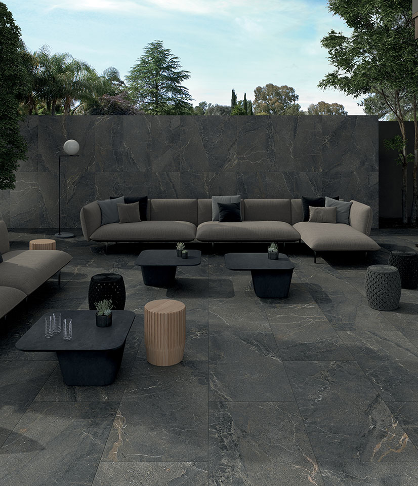 Anthology Dark Rough brings material elegance outdoors with dark stone-effect ceramic surfaces and seamless continuity between flooring and wall coverings.
